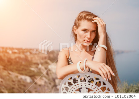 Happy boho woman portrait. Boho chic fashion style. Outdoor photo of free happy woman with long hair, sunny weather outdoors with sea mountains nature beautiful background. Happy boho woman portrait. Boho chic fashion style. Outdoor photo of free happy woman with long hair, sunny weather outdoors with sea mountains nature beautiful background. 101102004