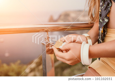 Hands, lock, heart, love, valentines day. Close-up of a woman's hands holding heart shaped padlock with a heart. The concept of Valentine's day, wedding, symbol of love and fidelity. 101102031