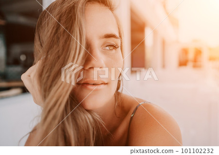 Happy woman portrait in cafe. Boho chic fashion style. Outdoor photo of young happy woman with long hair, sunny weather outdoors sitting in modern cafe. 101102232