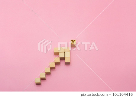 A front view of a pink background with a wood cube arrow rising to the right pointing to a woman sending an ale A front view of a pink background with a wood cube arrow rising to the right pointing to a woman sending an ale 101104416