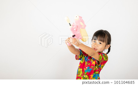 Happy Songkran Day, Asian kid girl with floral shirt hold water gun, Thai child funny hold toy water pistol and smile, isolated on white background, Thailand Songkran festival national culture concept 101104685