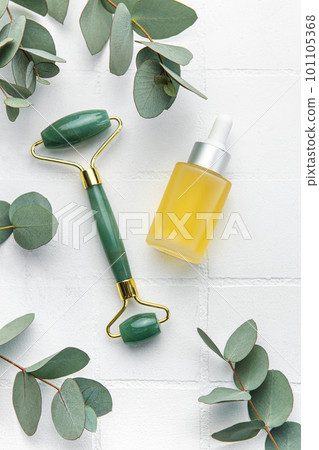 Spa treatment concept. natural spa cosmetics products with eucalyptus oil, massage jade roller, eucalyptus leaf. Spa treatment concept. natural spa cosmetics products with eucalyptus oil, massage jade roller, eucalyptus leaf. 101105368