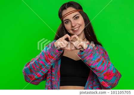 Smiling hippie woman makes heart gesture demonstrates love sign expresses good feelings and sympathy Smiling hippie woman makes heart gesture demonstrates love sign expresses good feelings and sympathy 101105705