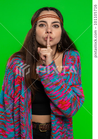 Young woman presses finger to lips makes silence gesture sign do not tells secret, stop gossip 101105716