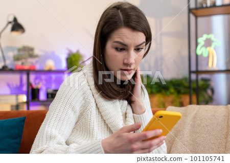 Sad young woman use smartphone surprised by bad news, fortune loss, fail, lottery results, deadline 101105741