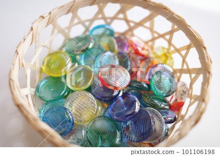 Colorful marbles in a basket 101106198