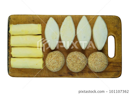 Assorted homemade semi-finished products on wooden board. Frozen cutlets, pancakes. Preparations of homemade food. 101107362