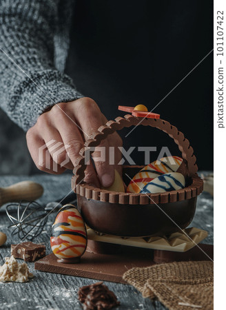 putting a chocolate egg in a spanish mona de pascua 101107422