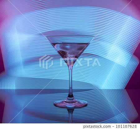 Martini cocktail in a glass against the background of neon lights Martini cocktail in a glass against the background of neon lights 101107628