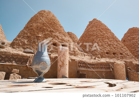 Roofs of beehive houses opposite bright clear sky 101107902