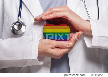 Doctor holding heart with flag of LGBT. Healthcare, charity, insurance and medicine concept 101108558