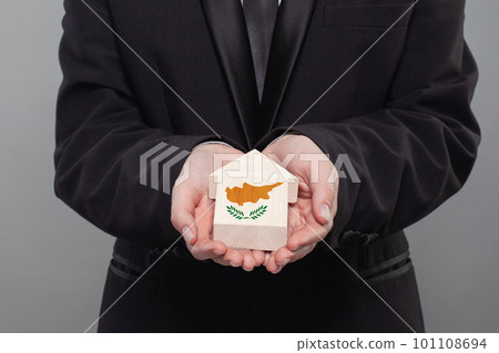 Cyprus person holding wooden house with flag of Cyprus Finance, investment, mortgage Cyprus person holding wooden house with flag of Cyprus Finance, investment, mortgage 101108694