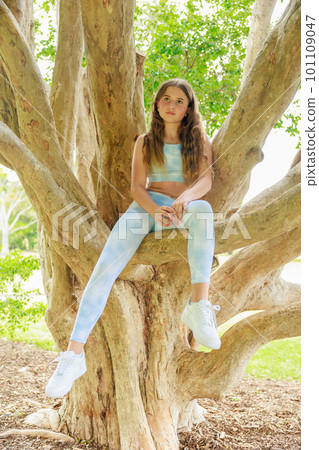 Australian girl climbing on a tree Australian girl climbing on a tree 101109047
