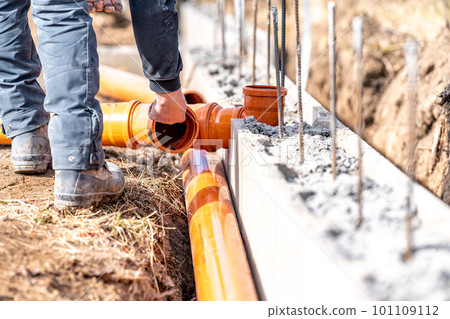installation of a sewage plastic pipe during the construction of a house installation of a sewage plastic pipe during the construction of a house 101109112