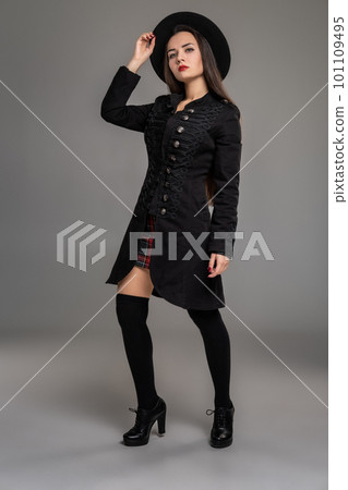 Full length portrait of a professional model posing at studio. 101109495