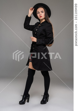 Full length portrait of a professional model posing at studio. 101109499