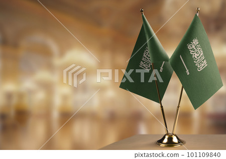 Small flags of the Saudi Arabia on an abstract blurry background Small flags of the Saudi Arabia on an abstract blurry background 101109840