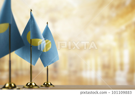 A small Palau flag on an abstract blurry background A small Palau flag on an abstract blurry background 101109883