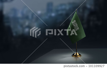 Small flags of the Saudi Arabia on an abstract blurry background 101109927
