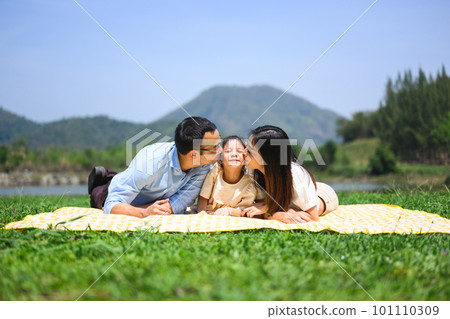 Happy family relaxing and playing outdoor together in park on weekend 101110309