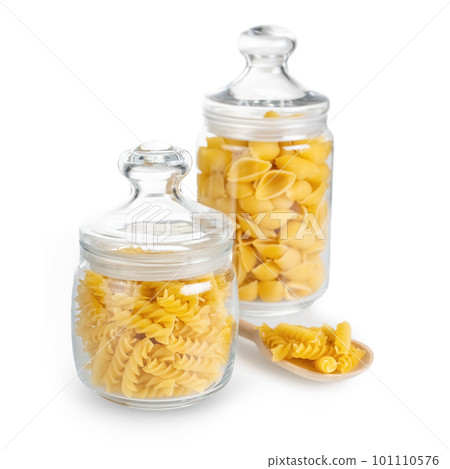 Raw pasta in glass jar isolated on white background 101110576