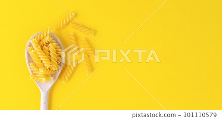 Raw pasta fusilli spaghetti pattern. Food background, italian cuisine Raw pasta fusilli spaghetti pattern. Food background, italian cuisine 101110579