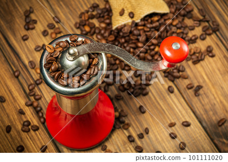 Coffee grinder and coffee beans on vintage boards. Idea for making a coffee drink top view 101111020