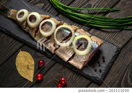 Dutch raw herring with onions and spices on serving board. The idea of snack for a street cafe or restaurant 101111030