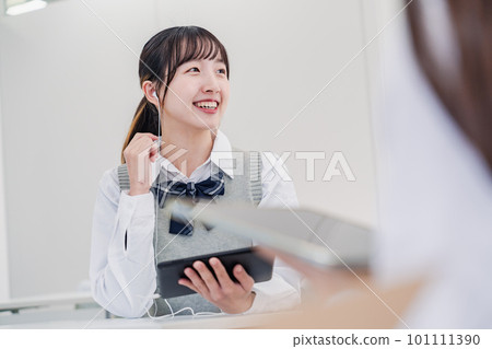 A high school student communicating with an international student using a translation app A high school student communicating with an international student using a translation app 101111390