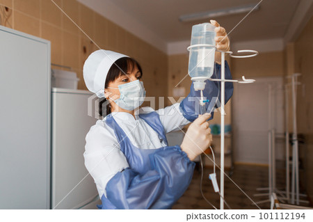 nurse anesthetist while in the hospital ward checks the counter drops. Doctor woman cares for the patient after the operation. Modern medicine nurse anesthetist while in the hospital ward checks the counter drops. Doctor woman cares for the patient after the operation. Modern medicine 101112194