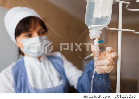 nurse in a hospital ward checks the counter drops. A female doctor takes care of the patient after surgery. The concept of cleansing the body nurse in a hospital ward checks the counter drops. A female doctor takes care of the patient after surgery. The concept of cleansing the body 101112256