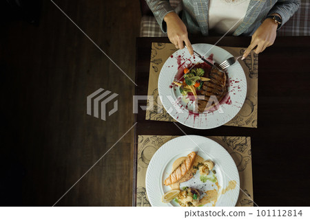Woman is having breakfast in a restaurant at the table. Time to have lunch. View from above. Healthy food 101112814