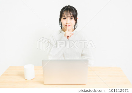 A young woman who makes a secret pose in front of a PC 101112971