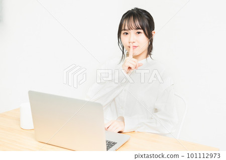 A young woman who makes a secret pose in front of a PC 101112973