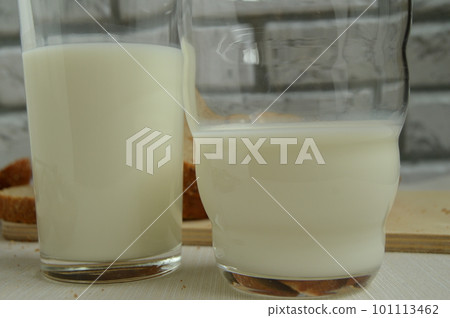 Two glasses of milk are on the table, Breakfast for the family, healthy eating concept Two glasses of milk are on the table, Breakfast for the family, healthy eating concept 101113462