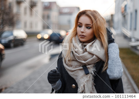 Elegant stylish young woman in fashionable autumn clothes walking down the street on the backdrop of modern buildings. Fashionable beautiful girl. Elegant stylish young woman in fashionable autumn clothes walking down the street on the backdrop of modern buildings. Fashionable beautiful girl. 101113464