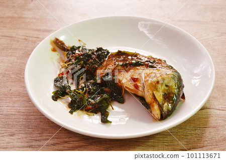 spicy boiled mackerel topping basil in chili sauce on plate spicy boiled mackerel topping basil in chili sauce on plate 101113671