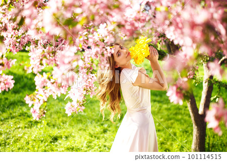 Spring Style. Beautiful Young Brunette Woman In Nice Spring Dress With A Bouquet Of Tulips. Spring Style. Beautiful Young Brunette Woman In Nice Spring Dress With A Bouquet Of Tulips. 101114515