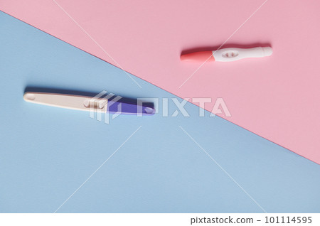 Rapid diagnosis of pregnancy. Pregnancy tests with two bars on isolated blue and pink color pastel background. Copy space. Women's health, gynecology and medicine concept. Planning maternity concept 101114595