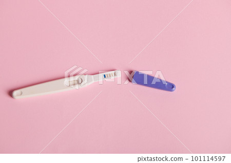 Still life. Inkjet pregnancy test with a positive result between human chorionic gonadotropin in the urine, isolated on a pink pastel background. Finally pregnant. Quick Pregnancy Detection. 101114597