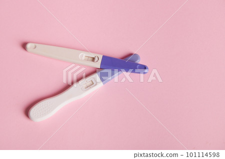 Flat lay. Still life. Positive pregnancy test on isolated pink pastel background with copy advertising space. Two bars showing positive reaction between female urine and HCG hormone. Finally pregnant 101114598