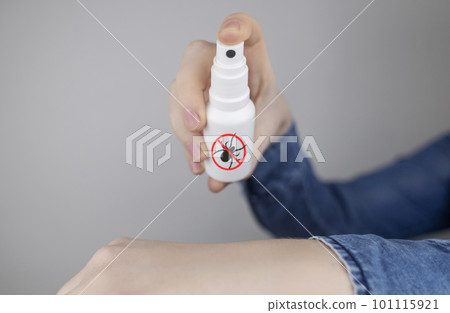 Tick repellant. Insect protection. Girl holds a spray on a white background that will protect against ticks. Repelling blood-sucking insects. Tick repellant. Insect protection. Girl holds a spray on a white background that will protect against ticks. Repelling blood-sucking insects. 101115921