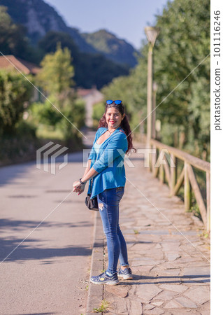 Active holiday vacation trip. Middle aged latin woman doing tourism excursion outdoor in Asturias 101116246