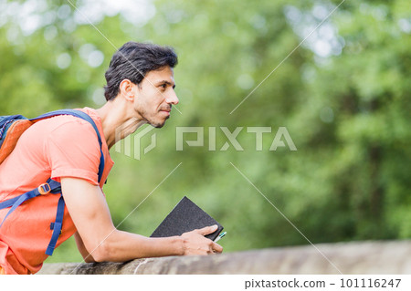 indian south asian backpacker. Thinking with happiness expression in an Asturias environmental Travel. 101116247