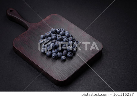 Delicious fresh blueberries on a textural black concrete background 101116257
