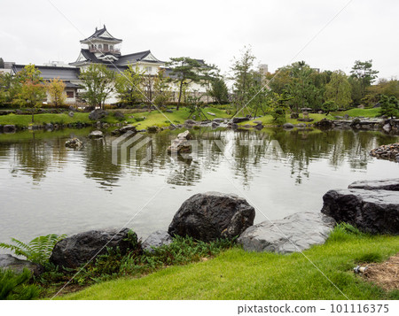 Traditional Japanese garden with pond and white castle in Toyama, Japan Traditional Japanese garden with pond and white castle in Toyama, Japan 101116375