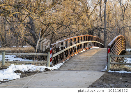 bike trail and footbridge over a river in winter or early spring - Cache la Poudre River in Fort Collins, Colorado bike trail and footbridge over a river in winter or early spring - Cache la Poudre River in Fort Collins, Colorado 101116552