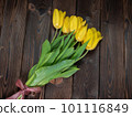 Yellow tulips lie on a wooden rustic table. Spring holidays concept background and mother day. 101116849