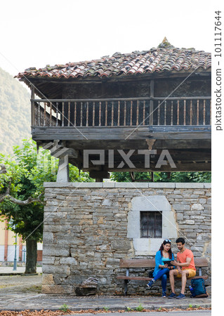 Asturias historical building Villanueva heritage. Mixed race couple together outdoor with tablet Asturias historical building Villanueva heritage. Mixed race couple together outdoor with tablet 101117644