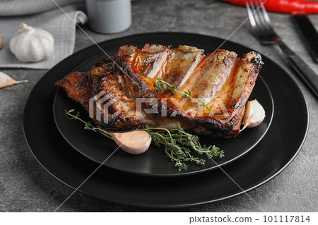 Tasty grilled ribs with thyme on grey table Tasty grilled ribs with thyme on grey table 101117814